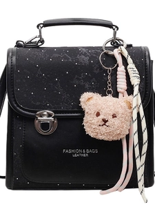 Fashionable black leather backpack for women featuring a starry glitter flap and plush charm