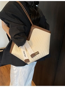 Vintage woven tote bag with brown leather trim and large capacity shown on a model
