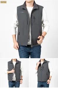 Detail view of men's reversible fleece vest showing zip pockets and stand collar in dark grey