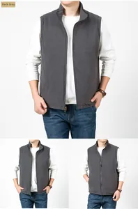 Detail of reversible grey fleece vest featuring a stand collar and functional zip pockets