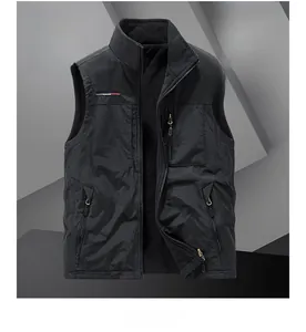 Detail view of the black outdoor vest showing green fleece lining and zipper pocket