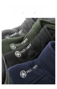 Detail of embroidered star logo on various colors of polar fleece vest fabric