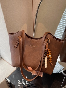 Retro dark brown PU leather tote bag with elegant beaded tassel and embossed lettering