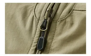Detail of olive green outdoor vest showing cotton spandex fabric and vintage metal zipper