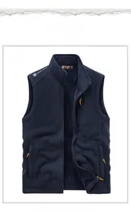 Detail of dark blue fleece vest featuring standing collar and secure zippered pockets