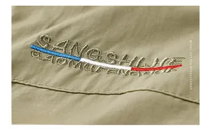 Detail of SANGSHINE embroidery and tri-color stripe on cotton spandex fabric vest