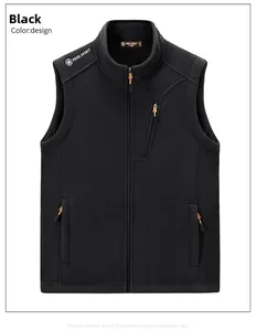 Detail of black fleece vest with FREE SPIRIT logo and orange accent zipper pockets