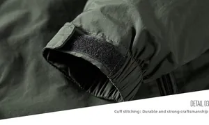 Detail 03: Macro view of olive green jacket cuff with velcro strap and reinforced stitching
