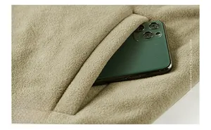 Detail of reversible fleece vest showing a secure khaki inner pocket for a smartphone