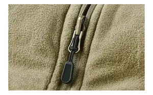 Detail of reversible zipper and fleece texture on olive green outdoor vest