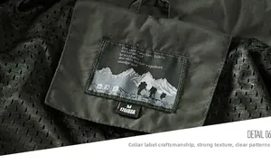 Detail view of the green tactical jacket's collar label and black mesh lining material