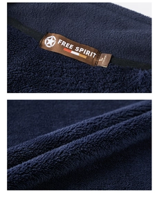 Macro detail of navy blue polar fleece texture and high-quality collar label stitching
