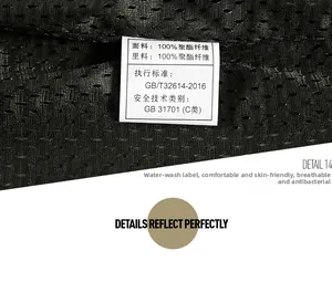 Detail of breathable black mesh lining and care label showing 100% polyester material