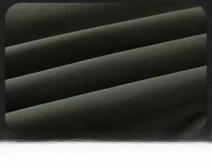 Close-up of warm dark green twill fabric showing thick texture and soft matte finish