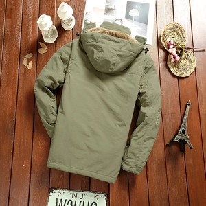 Rear view of bean green fleece-lined hooded jacket with faux fur trim on wooden floor