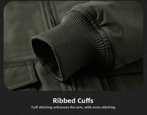 Close-up of ribbed cuffs and uniform stitching on olive green workwear cotton jacket
