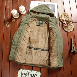 Detail of army green outdoor jacket featuring warm brown fleece lining and hood