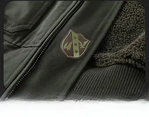Detail of dark army green winter jacket with plush lining and embroidered arm patch