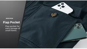 Detail view of large flap pocket with button on navy cargo jacket holding two smartphones
