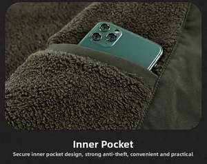 Detail shot of a secure inner pocket on a heavy green fleece jacket holding a smartphone