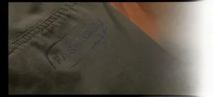 Close-up of olive green waterproof fabric showing double stitching and fashion print