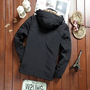 Flat lay of men's hooded fleece jacket with thick faux fur collar on dark wood background