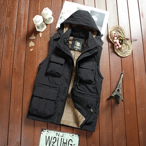 Detail of men's hooded jacket with black exterior and warm brown faux shearling lining