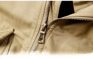Macro view of high-quality golden metal zipper and durable khaki cotton twill fabric detail