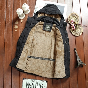 Flat lay of men's hooded jacket with warm fleece lining and zipper pockets on wood