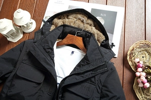 Detail view of the warm brown faux shearling lining and classic embroidery on jacket