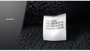 Detail of the washing label on the black sherpa fleece jacket with texture view