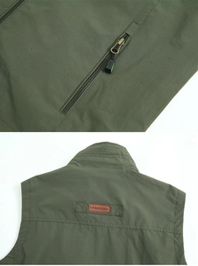 Detailed view of army green outdoor vest featuring a zipper pocket and leather fashion label