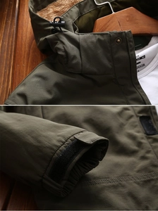 Detail of olive green jacket with warm fleece lining and adjustable velcro cuff