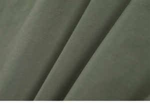 Detailed macro view of quick-dry moss green fabric texture with subtle silk sheen