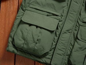 Macro detail of army green tactical jacket with multi-pocket design and durable fabric