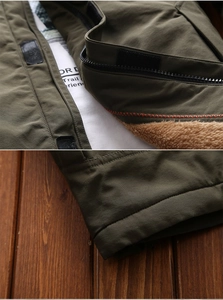 Detail of army green jacket with brown fleece lining and Velcro zipper flap closure