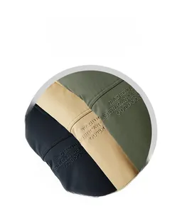 Detail of embroidered fashion text on fleece jacket in black, khaki, and army green