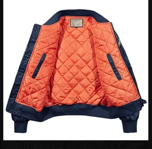 Detail of bomber jacket showing orange quilted lining and inner pockets with rib-knit collar