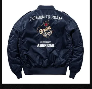 Detail of navy bomber jacket back with Freedom to Roam embroidery and red star motif