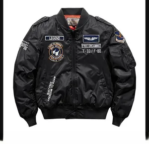 Detail of MA-1 flight jacket showing tactical embroidery patches and utility sleeve pocket
