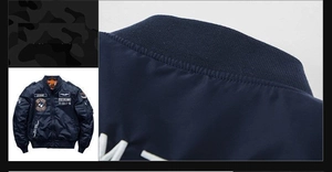 Detailed view of navy blue MA-1 flight jacket with vintage embroidery and ribbed collar