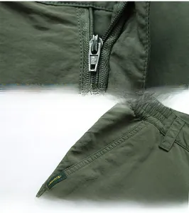 Détail de fermeture éclair en alliage et coutures renforcées sur pantalon d'extérieur