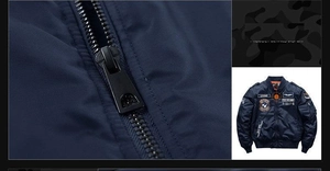 Detail of navy flight jacket with military badges and sturdy black metal zipper