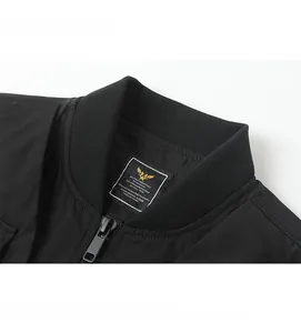 Detail of ribbed collar and metallic zipper on a black tactical bomber jacket