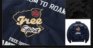 Detail of navy bomber jacket featuring Freedom To Roam embroidery and star back print