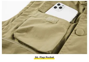 Close-up of khaki outdoor vest showing a large flap pocket with Velcro and phone storage