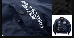 Detail of navy bomber jacket featuring flight embroidery and windproof nylon texture