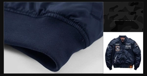 Detailed embroidery patches on navy MA-1 flight jacket with ribbed cuffs and collar