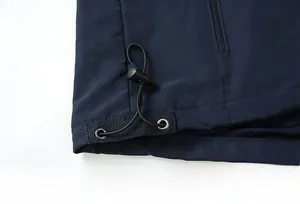 Detail of adjustable hem with elastic drawstring and breathable mesh lining on a blue vest
