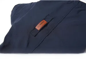 Detail of the navy blue jacket back featuring a classic brown leather patch and fine texture